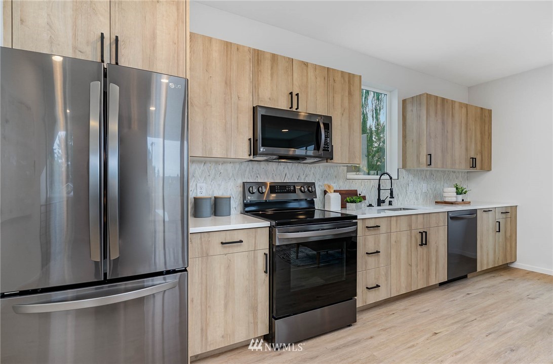 941 North 91st Street, Unit B Seattle, WA 98103 - Photo 11 of 23 a kitchen with a refrigerator stove and sink