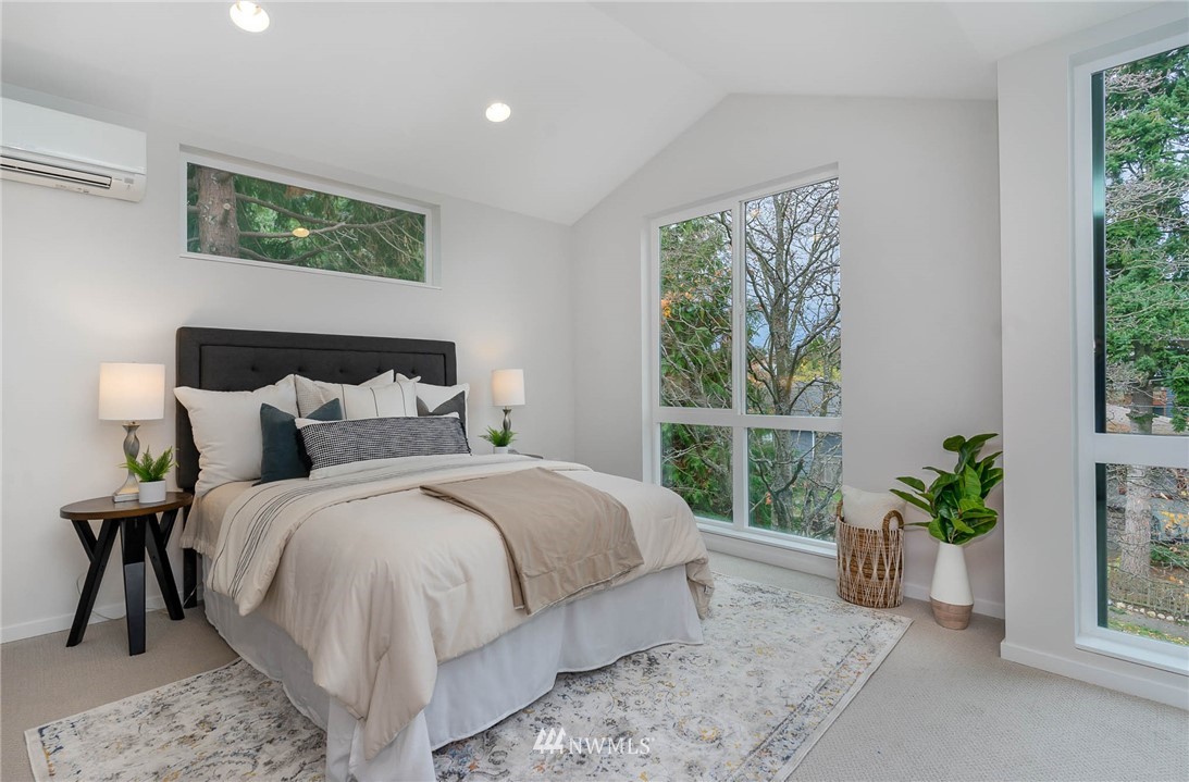 941 North 91st Street, Unit B Seattle, WA 98103 - Photo 16 of 23 a bed sitting in a bedroom next to a window