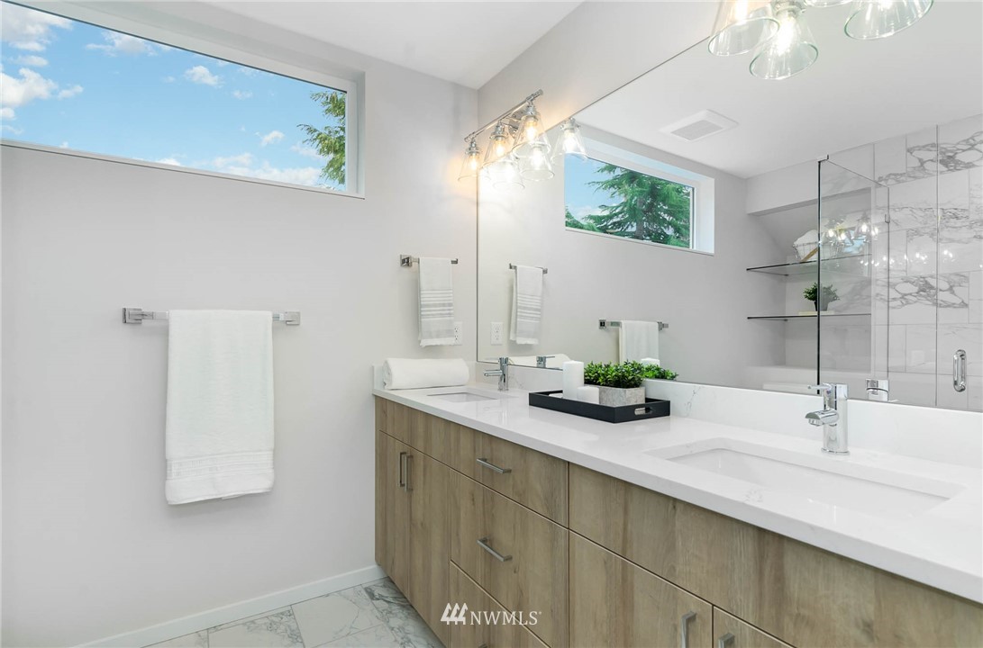 941 North 91st Street, Unit B Seattle, WA 98103 - Photo 18 of 23 a bathroom with a sink and a mirror