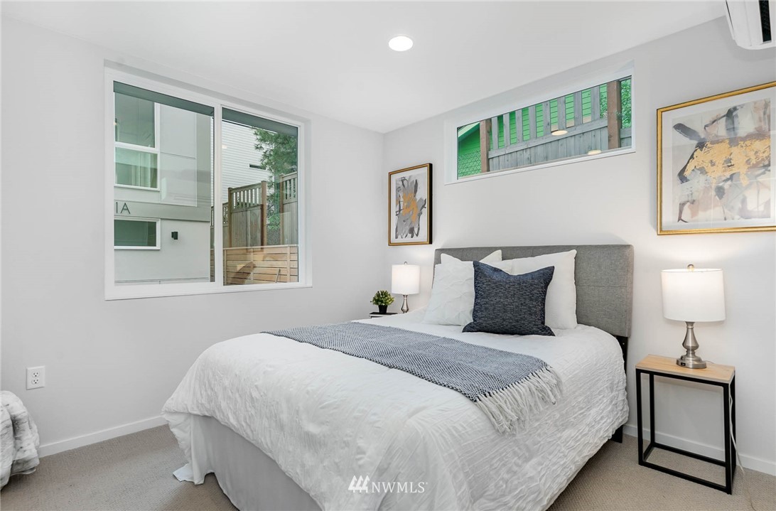 941 North 91st Street, Unit B Seattle, WA 98103 - Photo 4 of 23 a bedroom with bed and night stand