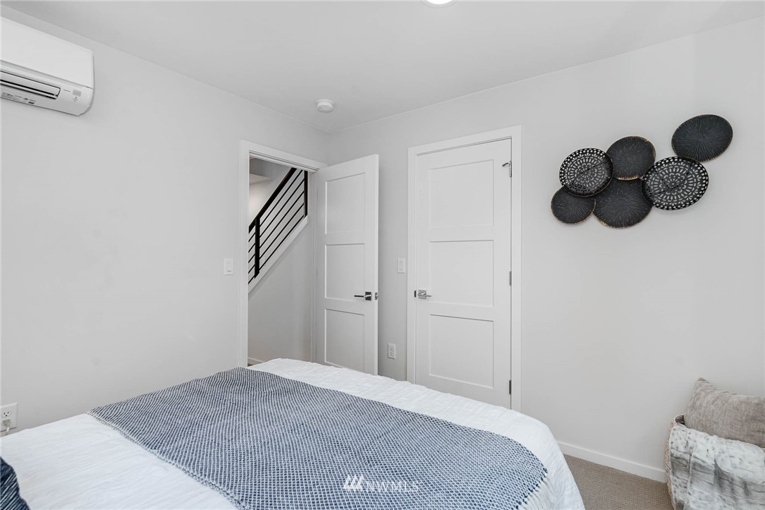 941 North 91st Street, Unit B Seattle, WA 98103 - Photo 5 of 23 a bedroom with a bed and cabinets
