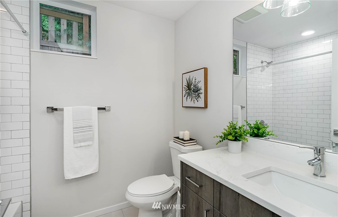 941 North 91st Street, Unit B Seattle, WA 98103 - Photo 6 of 23 a bathroom with a sink toilet and vanity