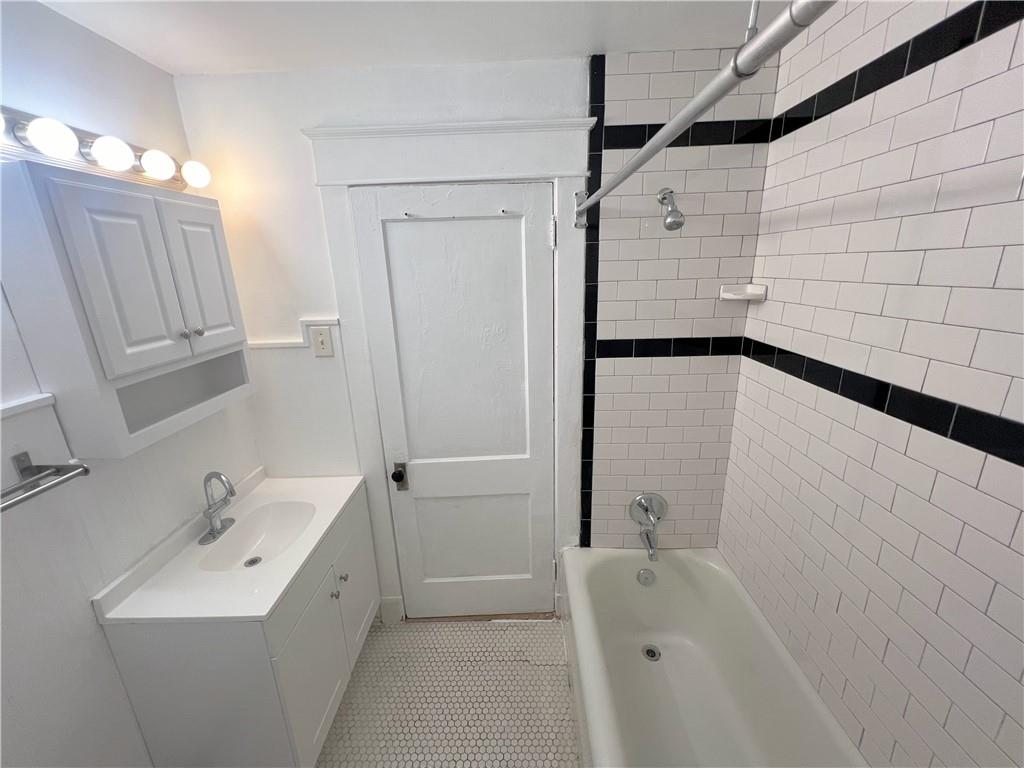 3904 Brighton Road, Unit 2 Pittsburgh, PA 15212 - Photo 4 of 6 a bathroom with a sink a toilet and shower