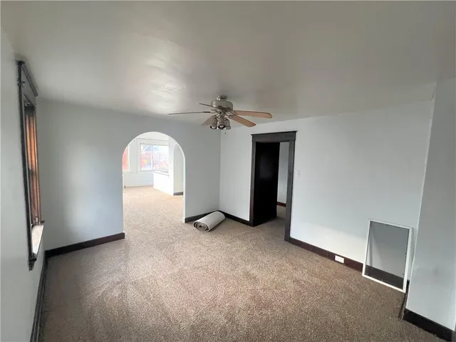 an empty room with windows and entrance