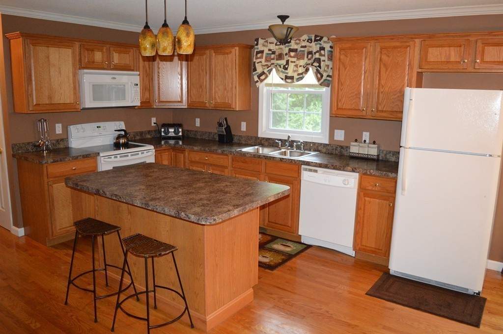 83 Stuart Street Springfield, MA 01119 - Photo 8 of 17 a kitchen with a sink a stove a refrigerator and cabinetry