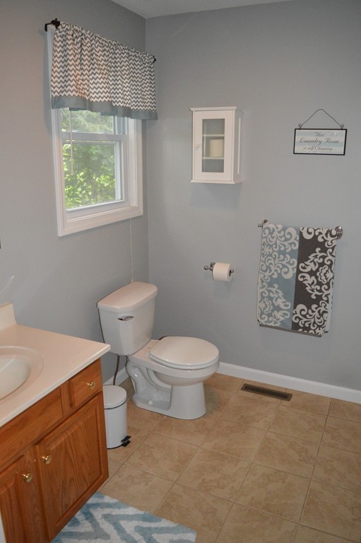 83 Stuart Street Springfield, MA 01119 - Photo 10 of 17 a bathroom with a toilet a sink and a window