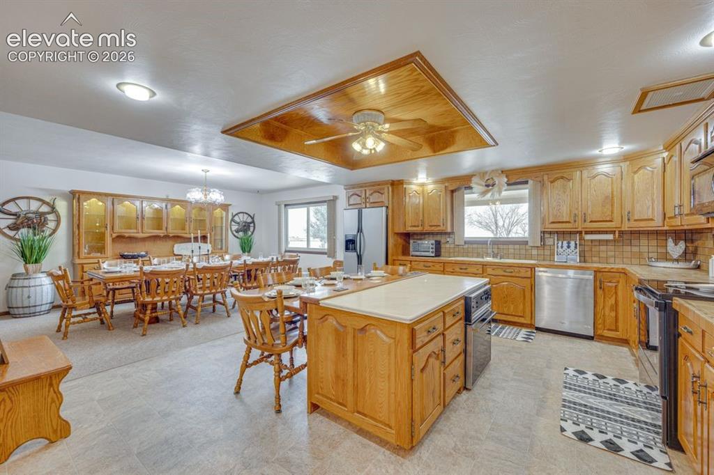 24760 Jones Road Calhan, CO 80808 - Photo 10 of 20 Kitchen with island, additional seating, and attached dining room