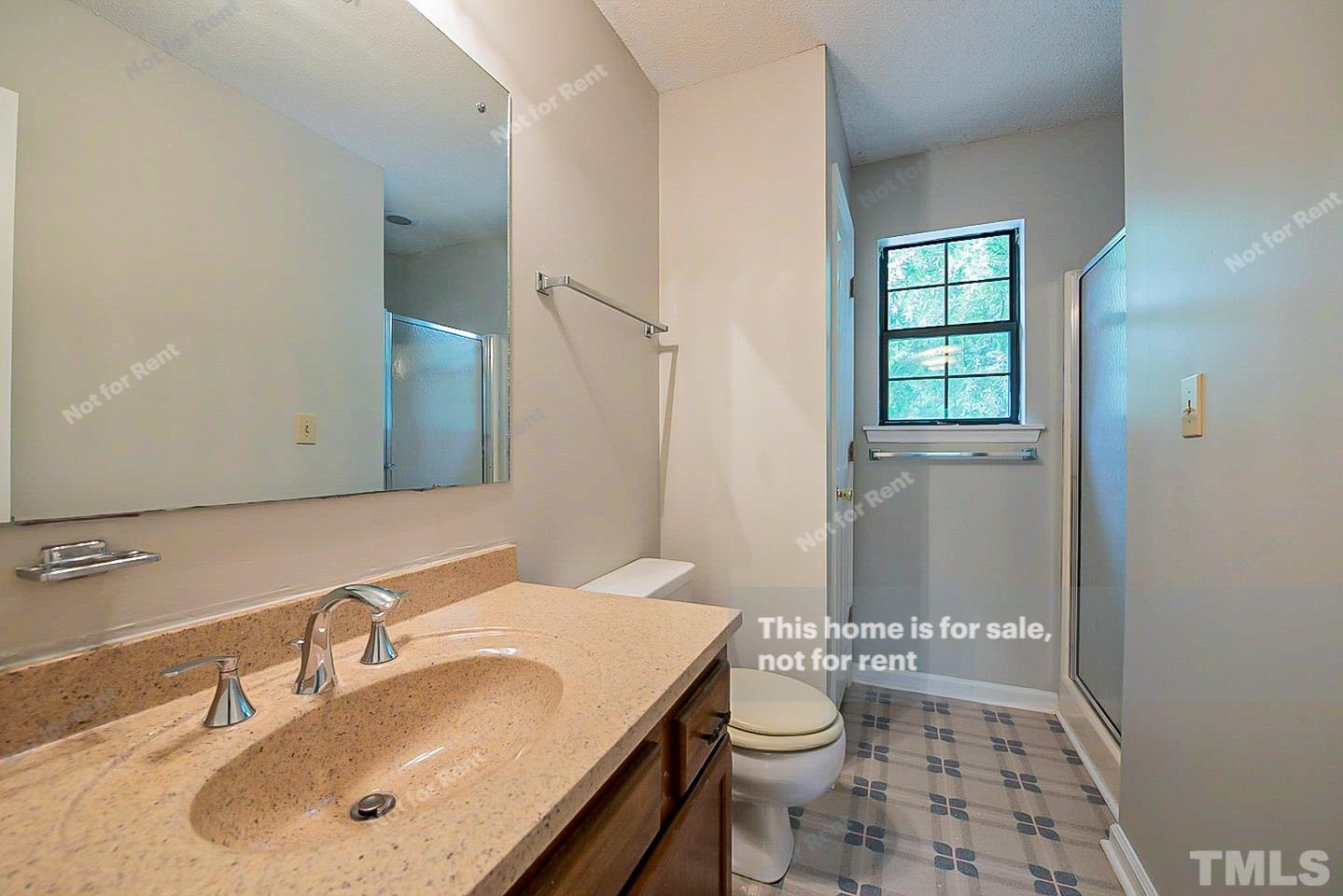 837 Horton Road Durham, NC 27704 - Photo 4 of 19 a bathroom with a sink a toilet and shower