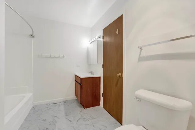 a bathroom with a shower and toilet