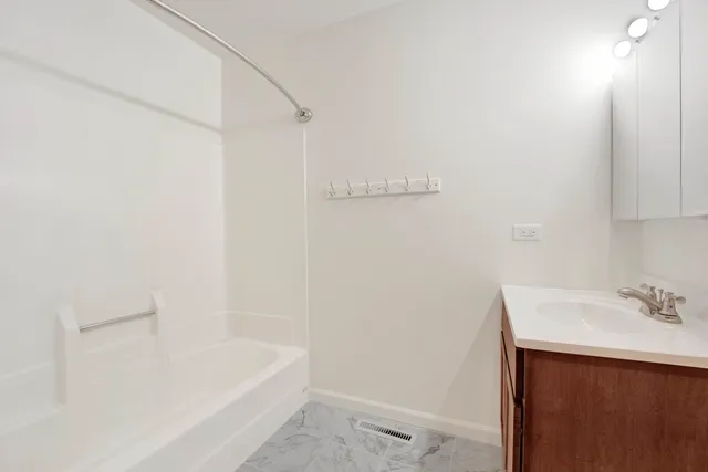 a bathroom with a bathtub and a sink