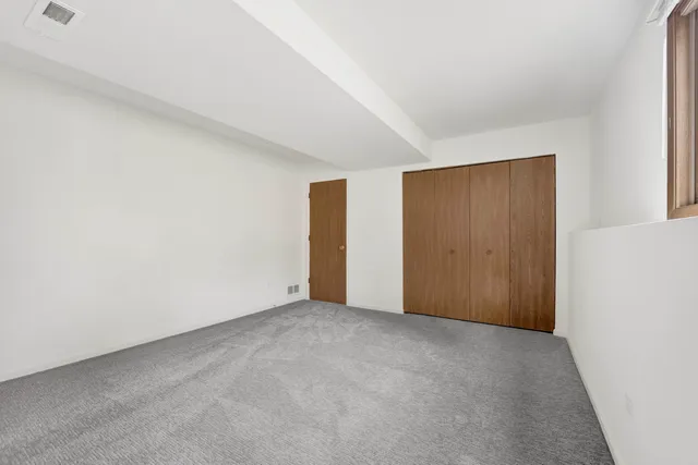 an empty room with closet area