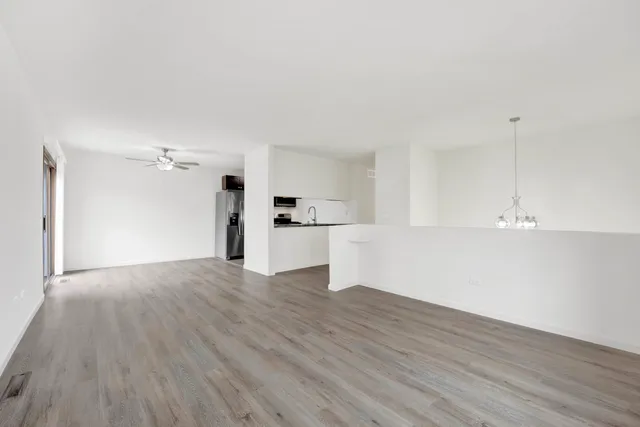a view of a kitchen with wooden floor and a sink
