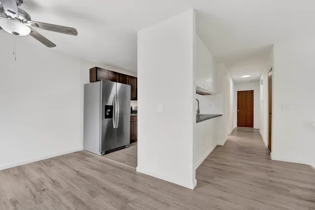 a view of a kitchen with a refrigerator and a sink