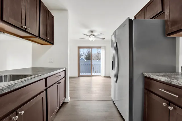 a kitchen with stainless steel appliances granite countertop a refrigerator and a sink