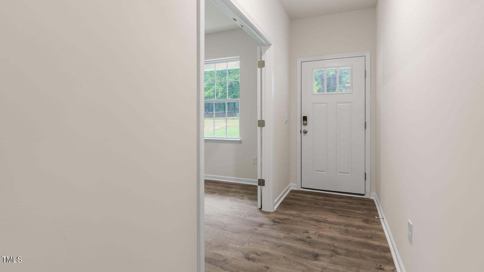 3125 White Memorial Church Road Willow Spring, NC 27592 - Photo 7 of 56 a view of an empty room with wooden floor and a window