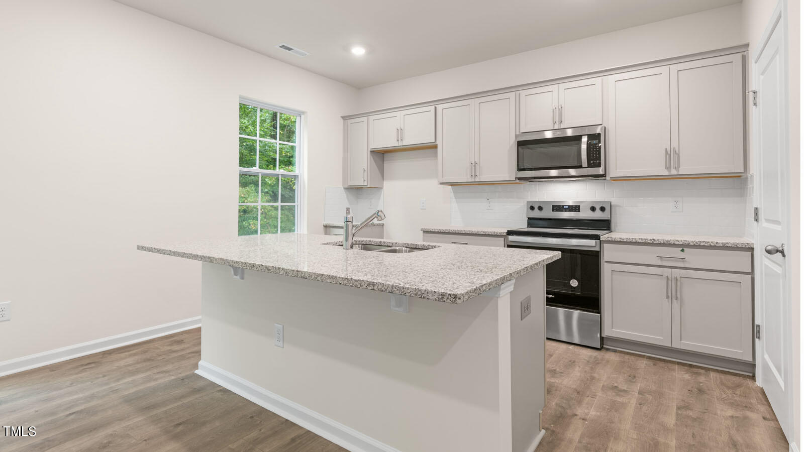 3125 White Memorial Church Road Willow Spring, NC 27592 - Photo 10 of 56 a kitchen with stainless steel appliances a sink stove and microwave