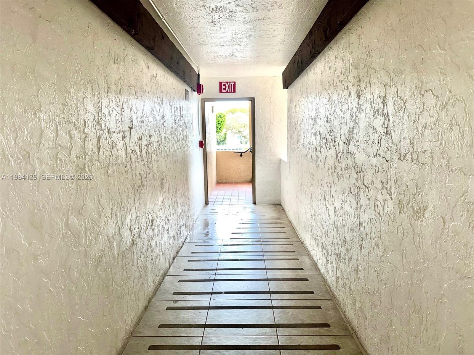 10700 Southwest 108th Avenue, Unit C209 Miami, FL 33176 - Photo 16 of 18 a view of a hallway with wooden floor and staircase