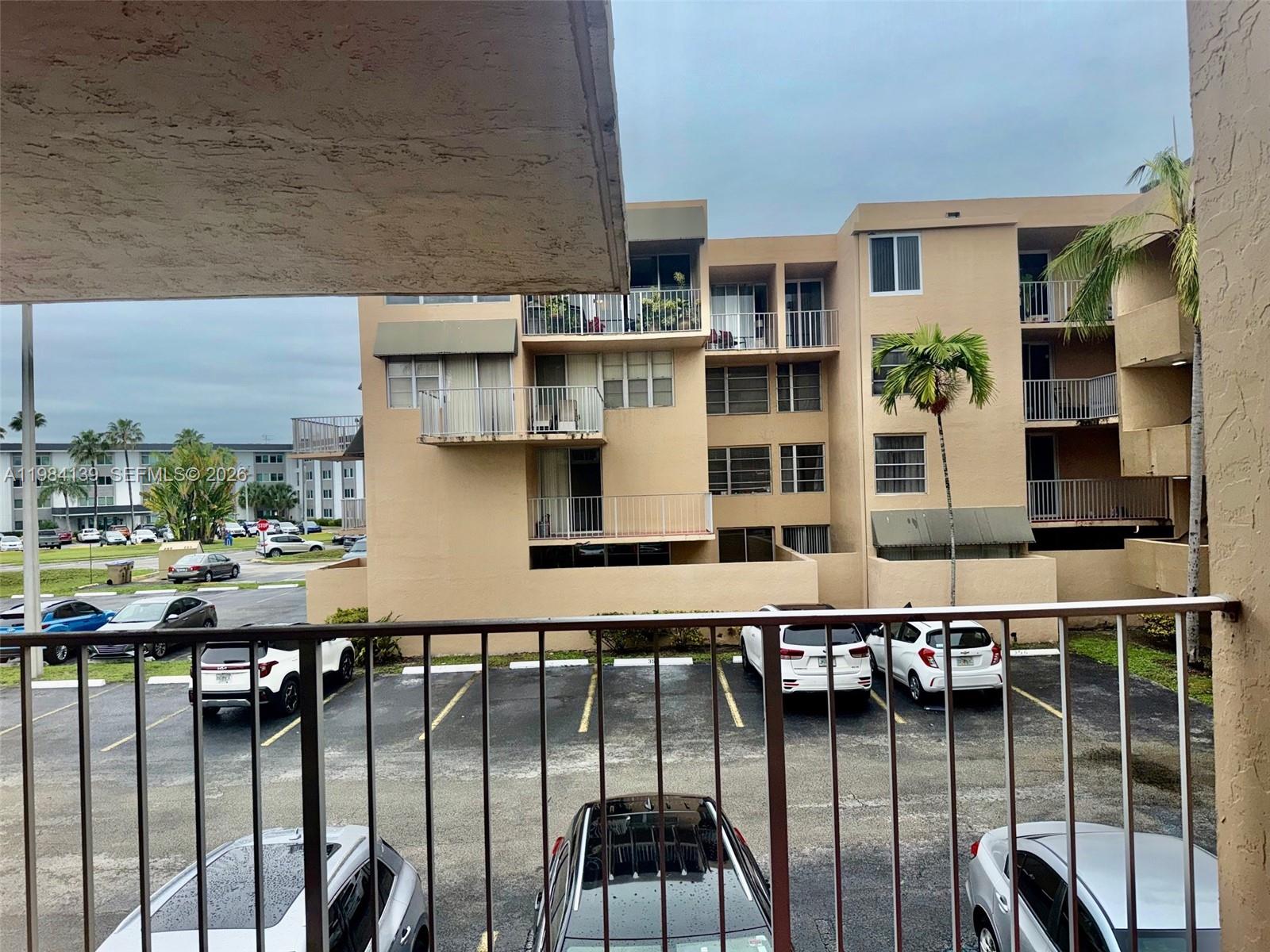 10700 Southwest 108th Avenue, Unit C209 Miami, FL 33176 - Photo 18 of 18 a view of a balcony with chairs and potted plants on the wall