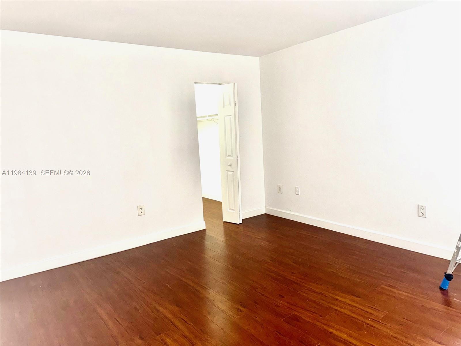 10700 Southwest 108th Avenue, Unit C209 Miami, FL 33176 - Photo 4 of 18 a view of an empty room with wooden floor