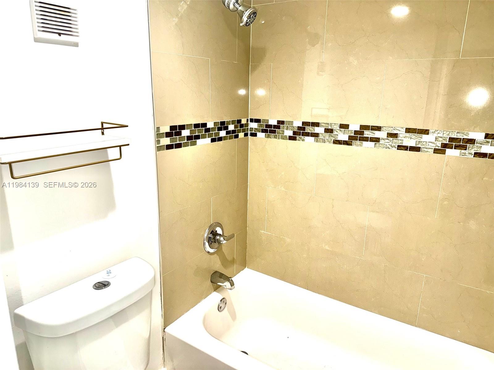 10700 Southwest 108th Avenue, Unit C209 Miami, FL 33176 - Photo 6 of 18 a bathroom with a shower a sink and a toilet