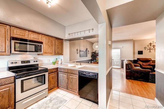 206 South Oman Road Castle Rock, CO 80104 - Photo 11 of 25 a kitchen with a stove and a microwave
