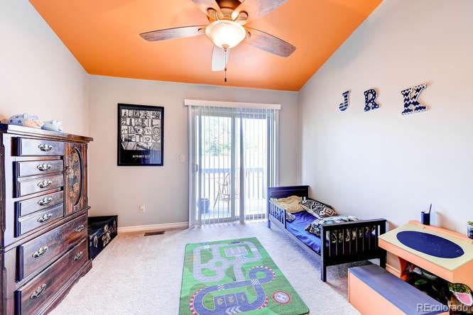206 South Oman Road Castle Rock, CO 80104 - Photo 17 of 25 a bedroom with a bed and a chandelier