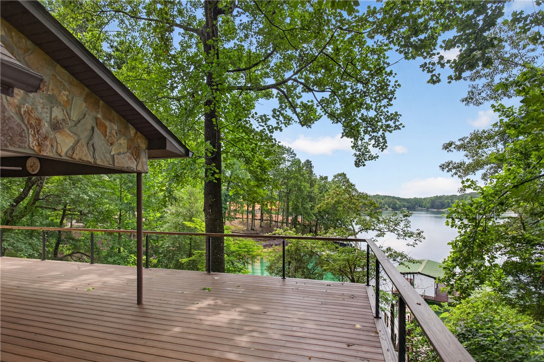 304 Lakeside Drive Seneca, SC 29672 - Photo 43 of 49 A spacious outdoor deck extends to a captivating waterfront vista surrounded by dense, mature trees.