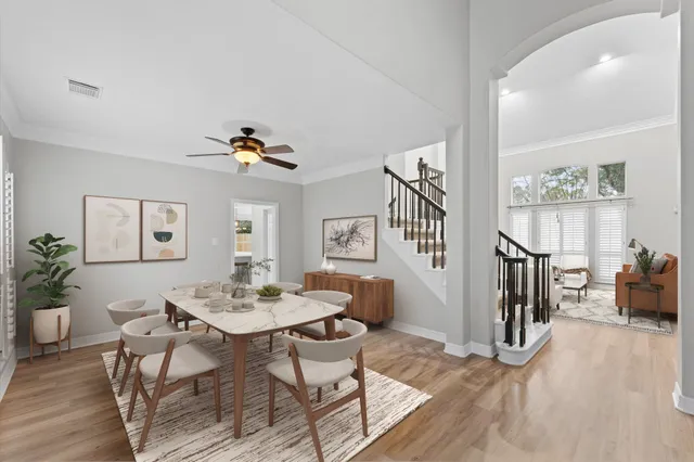 a view of livingroom with furniture large windows wooden floor and front door