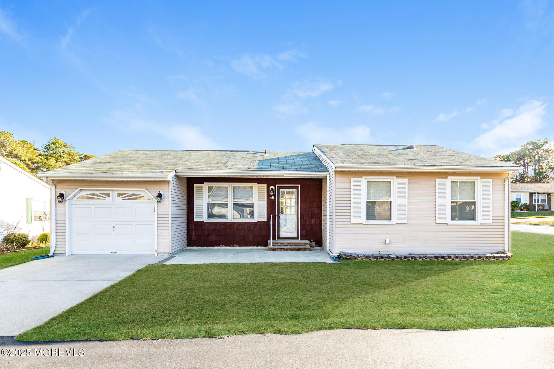 49 Westport Drive, Unit 71 Whiting, NJ 08759 - Photo 1 of 15 a front view of a house with a garden
