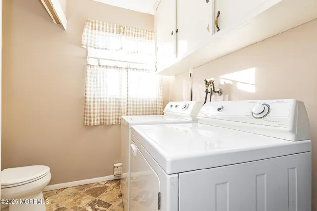 a bathroom with a sink a toilet and a window