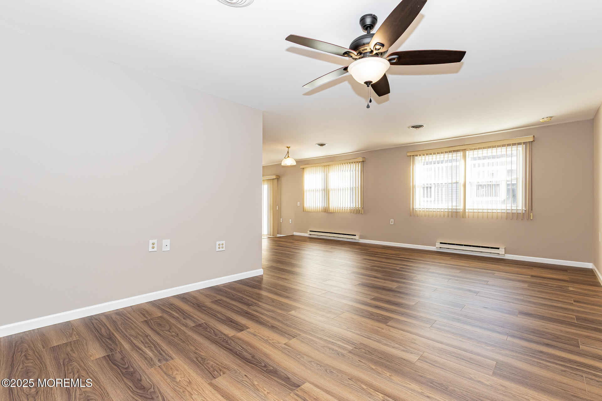 49 Westport Drive, Unit 71 Whiting, NJ 08759 - Photo 4 of 15 a view of an empty room with window and wooden floor
