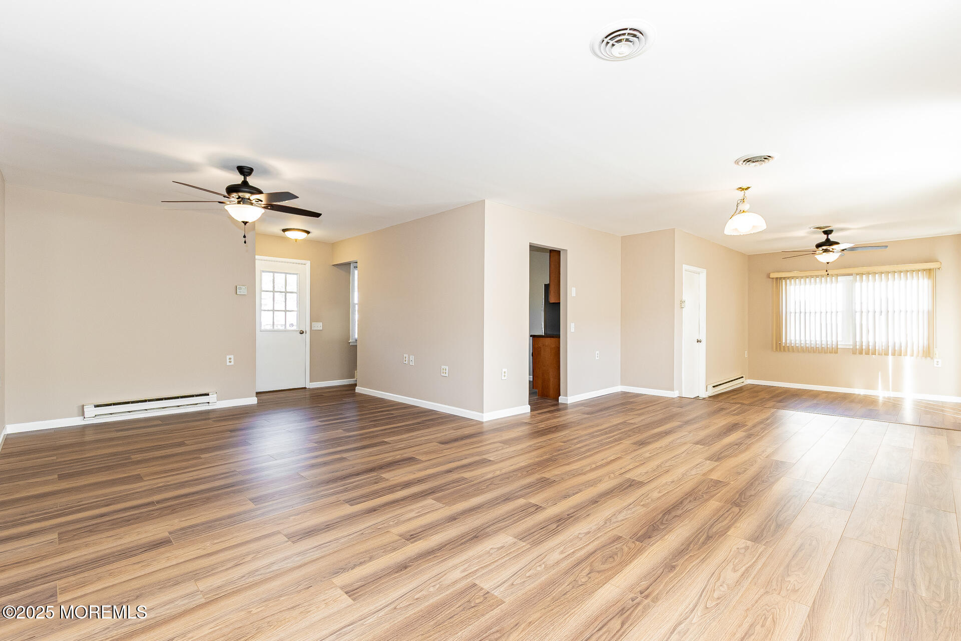 49 Westport Drive, Unit 71 Whiting, NJ 08759 - Photo 5 of 15 a view of an empty room with a window and wooden floor
