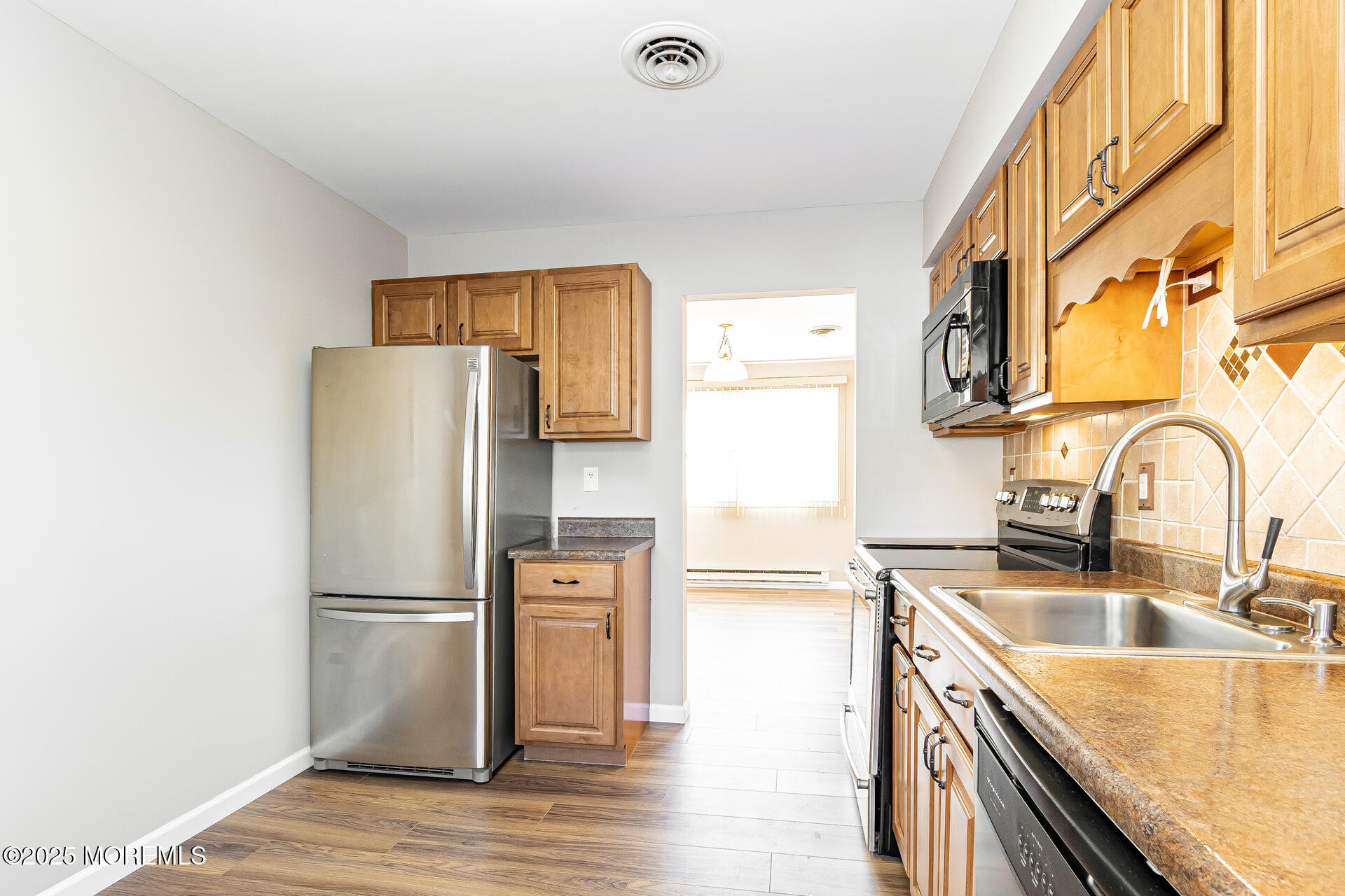 49 Westport Drive, Unit 71 Whiting, NJ 08759 - Photo 8 of 15 a kitchen with granite countertop a refrigerator and a sink