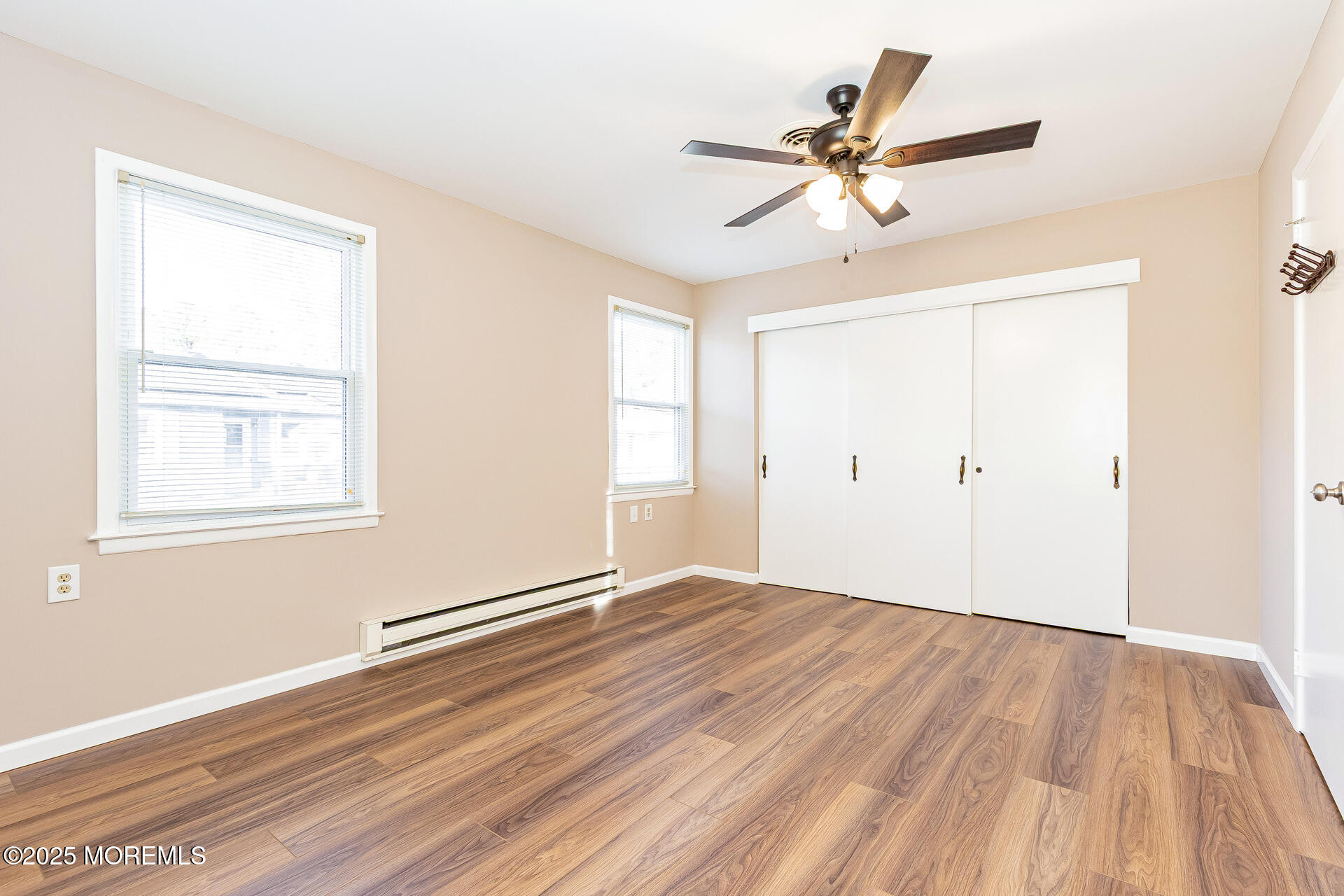 49 Westport Drive, Unit 71 Whiting, NJ 08759 - Photo 9 of 15 an empty room with wooden floor closet and windows