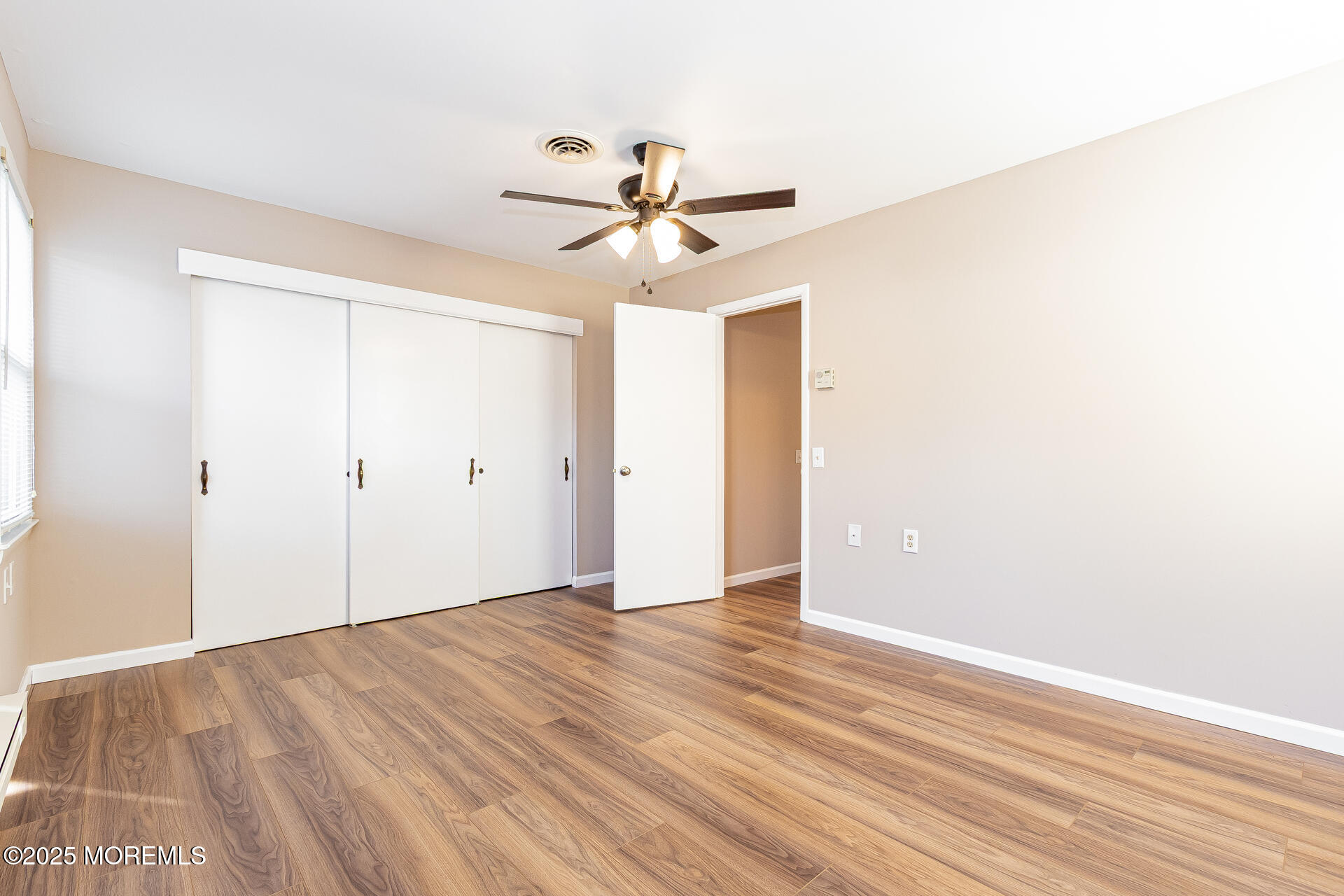 49 Westport Drive, Unit 71 Whiting, NJ 08759 - Photo 10 of 15 an empty room with fan and windows
