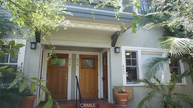 a front view of a house with a potted plant