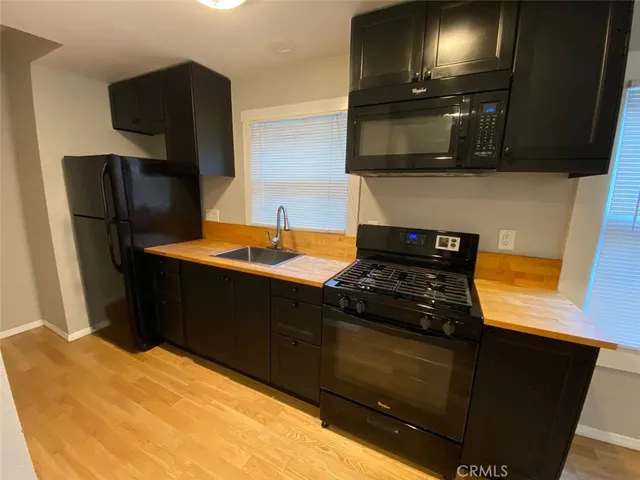 a kitchen with stainless steel appliances granite countertop a refrigerator and a stove