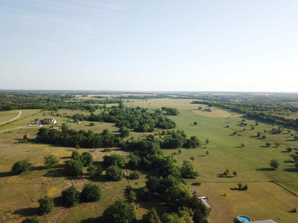 Tbd Ball Road Whitewright, TX 75491 - Photo 12 of 18 Expansive rural landscape featuring a mix of open fields and scattered mature trees