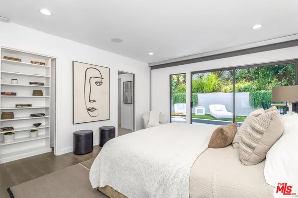 a bedroom with a bed and a large window