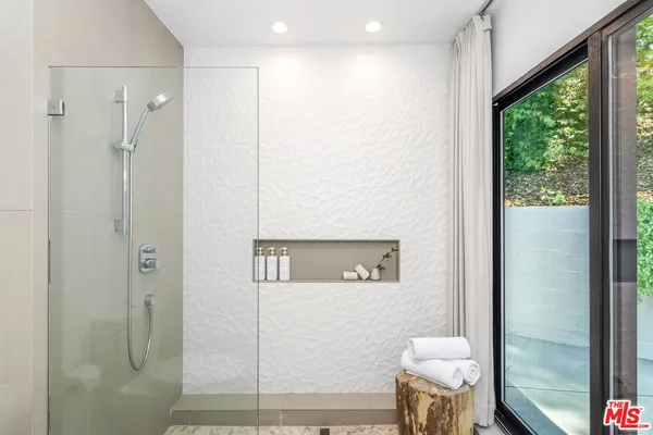 a bathroom with a toilet and a shower