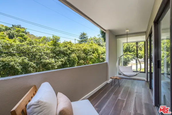 a view of roof deck with wooden floor and outdoor seating