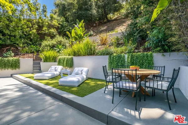 a view of a chairs and table in the patio