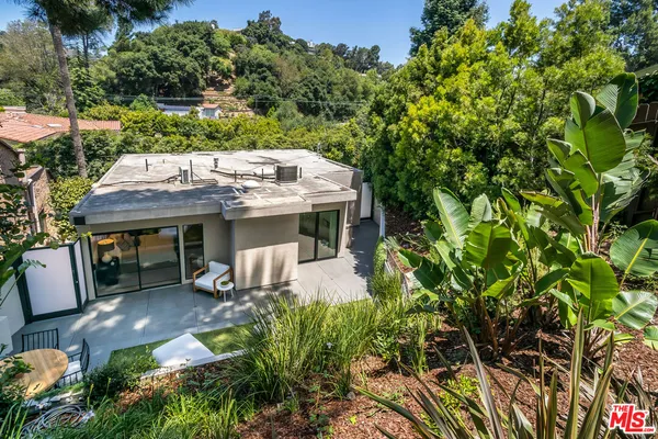 an aerial view of a house with yard table and chairs