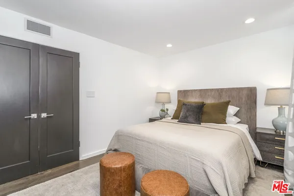 a bedroom with a bed and a night stand