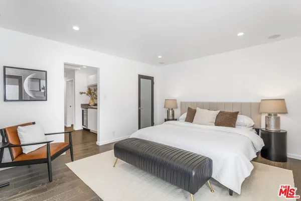 a spacious bedroom with a bed and a couch