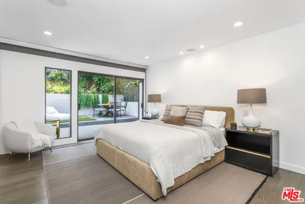 a bedroom with a bed and a couch