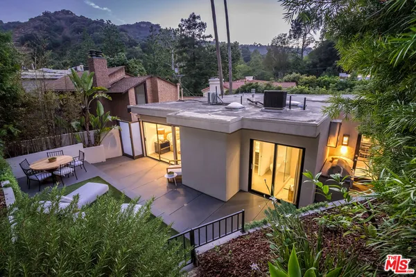 a view of house with a swimming pool and outdoor seating
