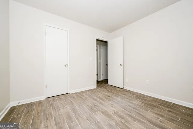 an empty room with wooden floor