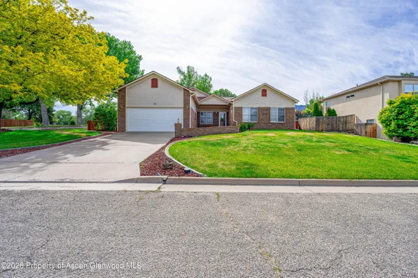 a house view with a garden space and street view