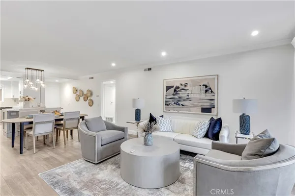 a living room with furniture and a large mirror